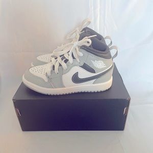 Kids Air Jordan 1 size 11c. Color gray,black, and white use in good condition.